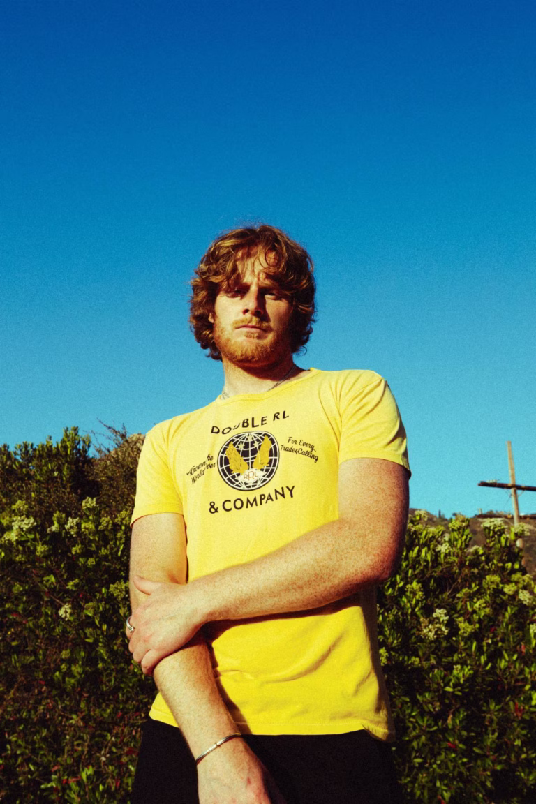 Matt Hansen in a yellow shirt beneath a clear blue sky