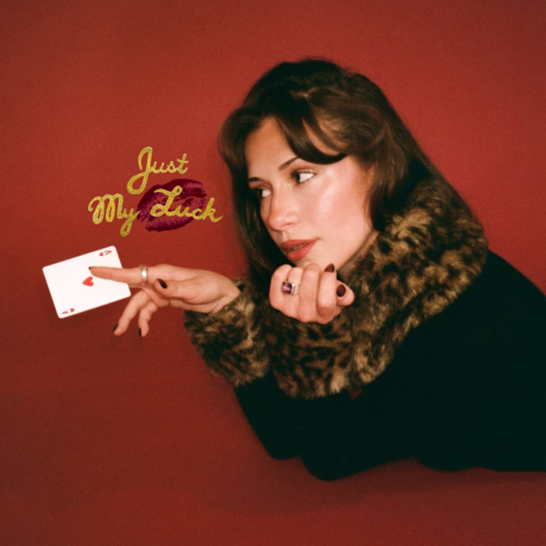 Maya Engen holding a playing card on the red Just My Luck EP artwork