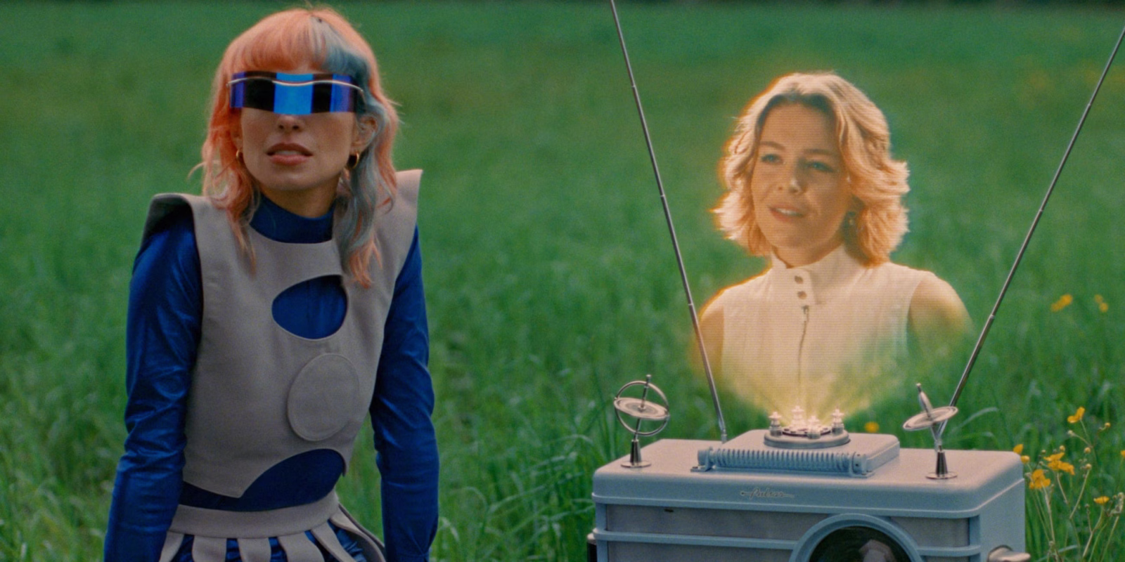 Blue visor and sculptural costumes in the Any Way video by L’Impératrice featuring Maggie Rogers.