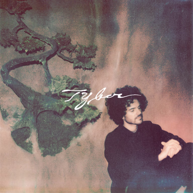 FKJ’s Tyber album cover, showing the musician beside a tree against a softly textured background.