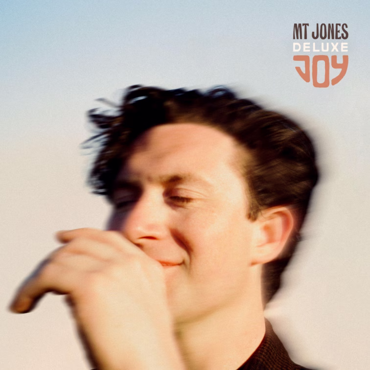 MT Jones JOY Deluxe album artwork, featuring a close-up portrait against a pale blue background.