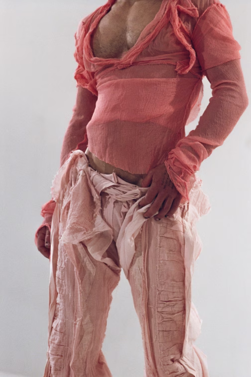 Close view of a Paolo Carzana Autumn Winter 2026 look in layered rose-colored fabric