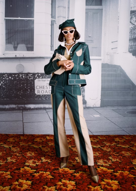 Model in a tailored green and cream Tolu Coker look with matching hat and white sunglasses