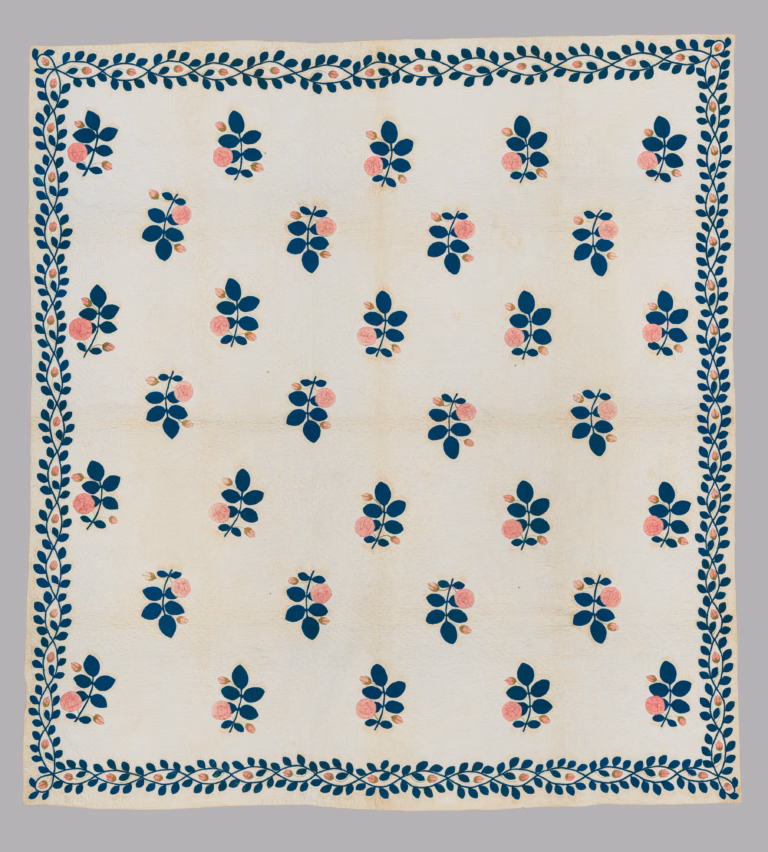 American appliquéd quilt with rows of pink rose sprigs and dark blue-green leaves on a pale ground, surrounded by a leafy border.