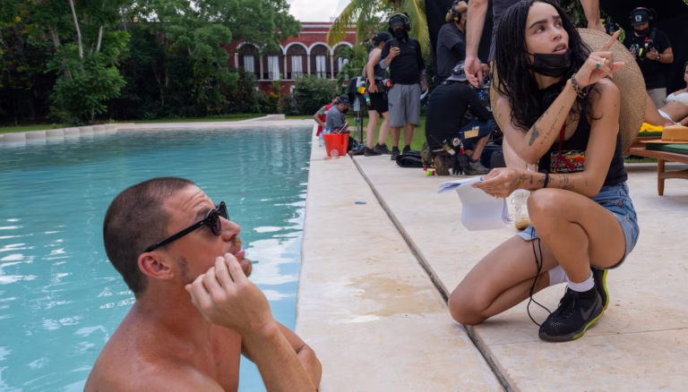 Zoë Kravitz directs beside a pool while Channing Tatum listens on the set of Blink Twice.